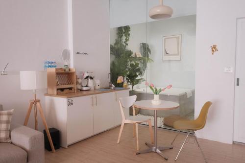 a kitchen with a table and chairs in a room at Privacy Home in Tainan