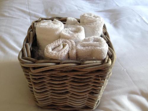 a basket filled with towels on a bed at B&B Capitaine Piret in Brussels