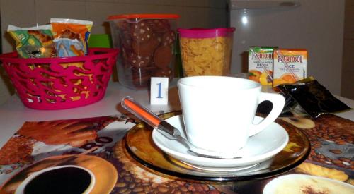 a table with a cup of coffee and snacks at B&B A Casa Dei Nonni in Capua