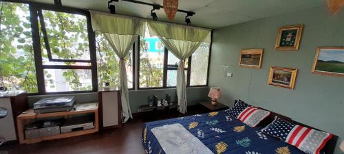 a bedroom with a bed and some windows at Green Homestay in Hanoi