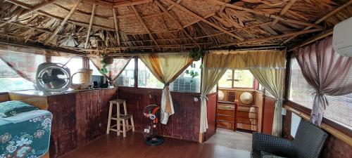 a room with a wooden ceiling and a room with a stool at Green Homestay in Hanoi