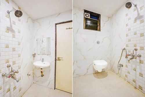 a bathroom with a toilet and a sink at Sai Vidisha Palace in Shirdi