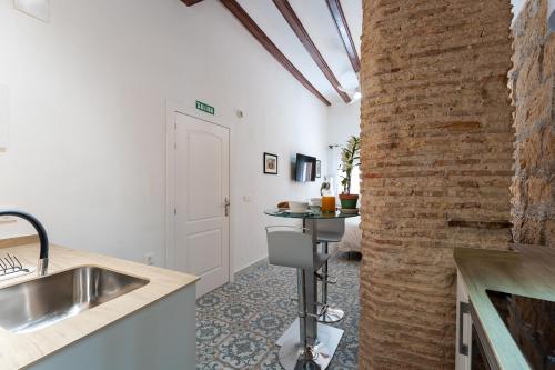 a kitchen with a sink and a brick wall at Tosca 2 PAX by costablancarent in Denia