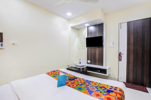a room with a colorful rug on the floor at FabExpress The Grand Kohinoor - Behind APMC in Turambhe