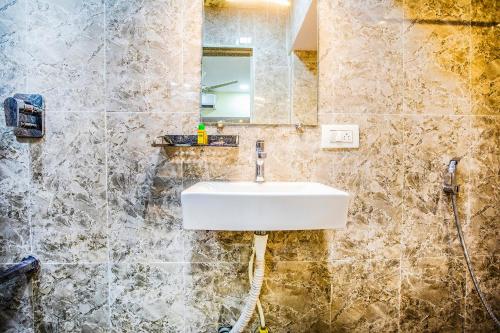 a bathroom with a sink and a mirror at FabExpress The Grand Kohinoor - Behind APMC in Turambhe