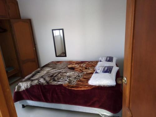 a bedroom with a bed with a tiger print blanket at Bonito apartamento en Cartagena con garaje gratuito in Cartagena de Indias