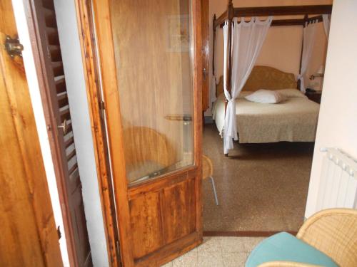 a door leading to a bedroom with a bed at Albergo Casa Al Sole in Greve in Chianti