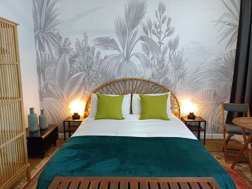 a bedroom with a large bed with green pillows at The Old Church Maleny in Maleny