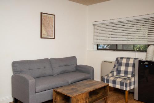 a living room with a couch and a chair at The Occidental Lodge in Occidental