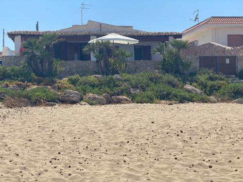 a house on a sandy beach with a house at La Casa sulla Spiaggia: Dimora Elma in San Lorenzo