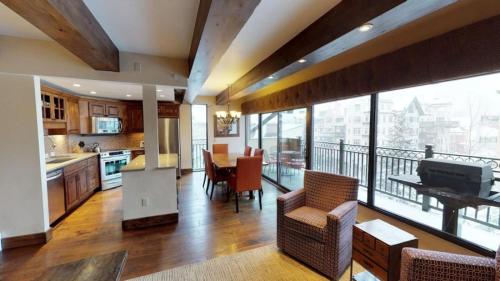 a large kitchen and dining room with a balcony at Luxury 2 Bedroom Lionshead Village Condo, Short Walk To Gondola in Vail