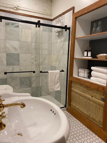 a bathroom with a tub and a glass shower at Lander Millhouse in Lander