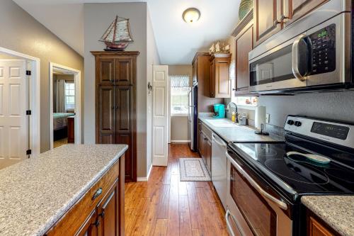 a kitchen with wooden cabinets and a stove top oven at Woodpecker Watchtower in Branson