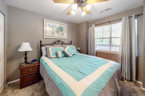 a bedroom with a bed and a ceiling fan at Woodpecker Watchtower in Branson