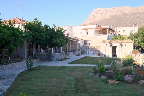 a yard with a house with a mountain in the background at Sophia Town Square Areopoli in Areopolis