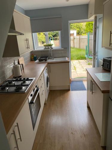 a kitchen with a sink and a stove top oven at Springfield Retreat in Risca