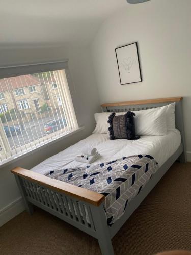 a bed with a teddy bear on it in a bedroom at Springfield Retreat in Risca