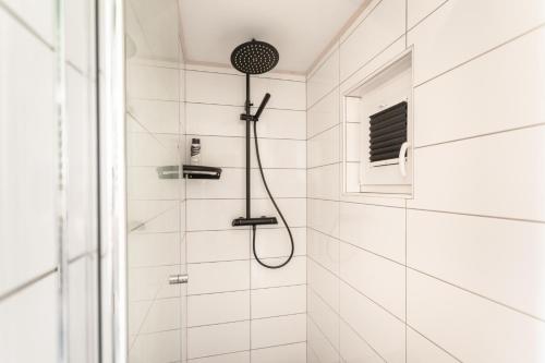 a shower with a shower head in a bathroom at Lavender Lodge Bled in Bled