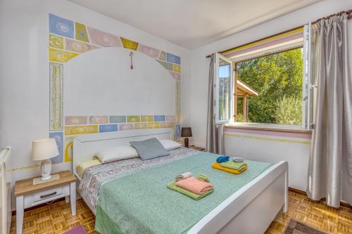 a bedroom with a bed with towels on it at Apartments Vivijana in Rabac