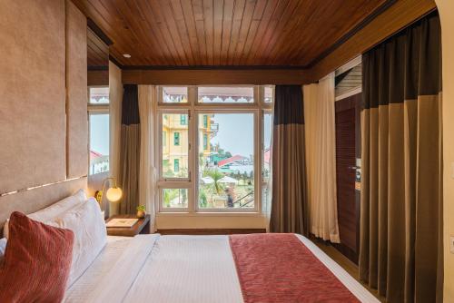 Postel nebo postele na pokoji v ubytování Udaan Nirvana Resort, Darjeeling