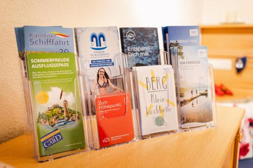a bunch of books sitting on top of a table at Heimeliges Apartment in den Bergen in Bad Kleinkirchheim