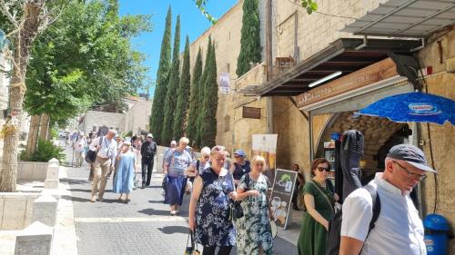 a group of people walking down a street at La Casetta in Nazareth