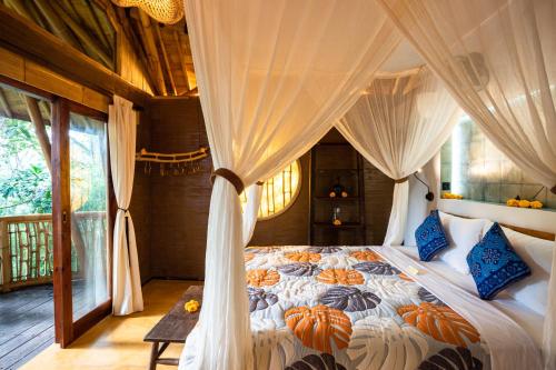 a bedroom with a bed with pumpkins on it at Bamboo Turtles Ecolodge in Ubud