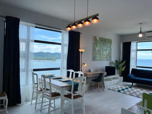 a living room with a table and chairs and a dining room at Private Corner Stay! Ocean-View, Walk to Jetty & Food Spots-Mango House1 in Kota Kinabalu