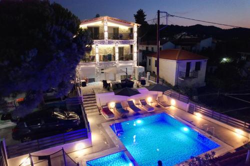 an aerial view of a house with a swimming pool at night at Luka 1 Aparts Polichrono in Polykhrono