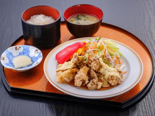 a tray with a plate of food and a bowl of soup at SPA HOTEL YUTTARIKAN in Satsumasendai