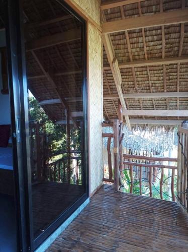 an open glass door to a patio with a porch at OcamOcam Azur Inn in Busuanga