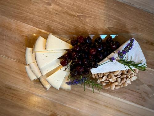 a bunch of cheese and grapes and nuts on a table at Aqua Et Oleum in Villamiel