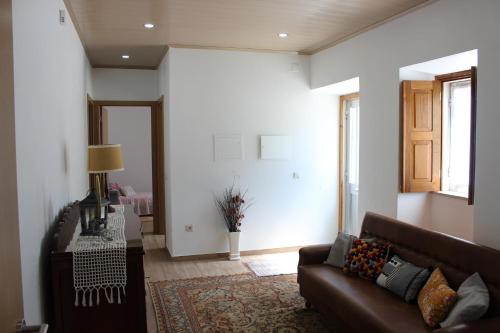a living room with a couch and a table at Casa do Avô Pedro in Lagar Novo