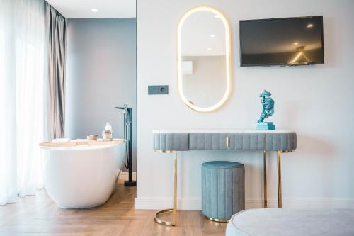 a bathroom with a tub and a sink and a mirror at Apartments Eneida in Ulcinj
