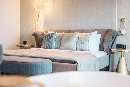a bedroom with a couch and a bed with pillows at Apartments Eneida in Ulcinj