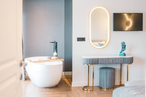 a bathroom with a sink and a tub and a mirror at Apartments Eneida in Ulcinj