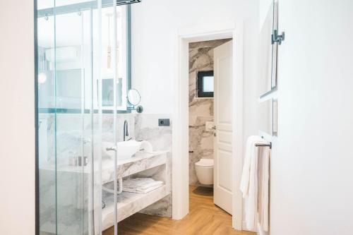 a bathroom with a glass shower and a sink at Apartments Eneida in Ulcinj