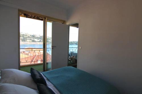 a bedroom with a bed and a view of the ocean at Excellent location - Sea Views in Villefranche-sur-Mer