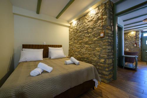 a bedroom with a bed with two towels on it at Kalochori Luxury Cottage 