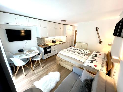 a small room with a bed and a table at 2022 Neu renoviert- Apartments Michaela in Philippsreut