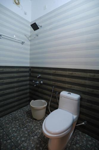 a bathroom with a toilet and a bidet at Wanderlust Residence Homestay in Thekkady