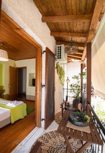 a room with a bed and a balcony at Olga in Nikiana