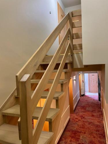 a staircase in a house with wooden steps at Hotel Kahlberg in Krynica Morska