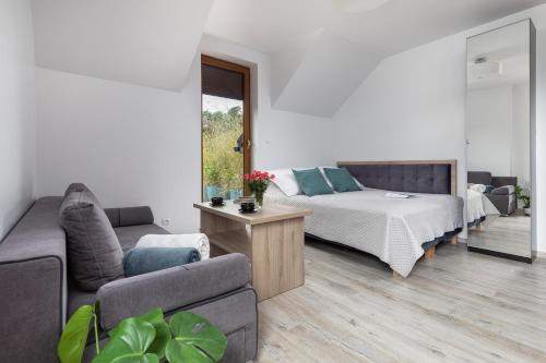 a living room with a bed and a couch at Na mieczowej 2f in Świnoujście