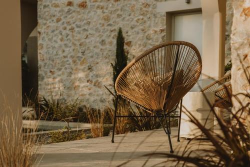 a chair sitting on a sidewalk next to a building at BATU Luxury Apartments in Preveza