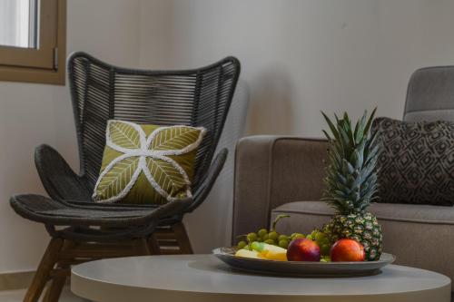 a bowl of fruit on a table in a living room at Andy's & Hari's Elegant Town Studios in Zakynthos Town
