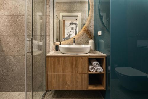 a bathroom with a sink and a mirror at Bella Vita Apartments in Rijeka