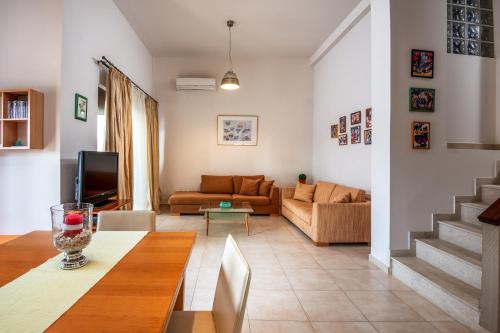 a living room with a couch and a table at Blue Wave Villa - road view in Gennadi