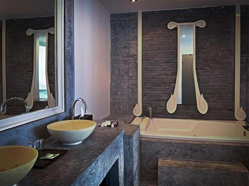a bathroom with two sinks and a bath tub at Sand Sea Resort & Spa - Lamai Beach , Koh Samui in Lamai