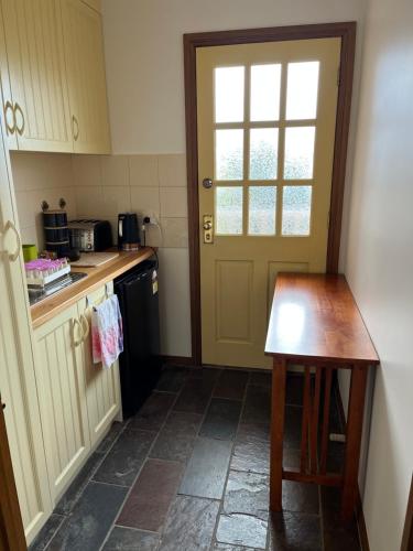a kitchen with a door and a table in it at Bicheno getaway for two in Bicheno